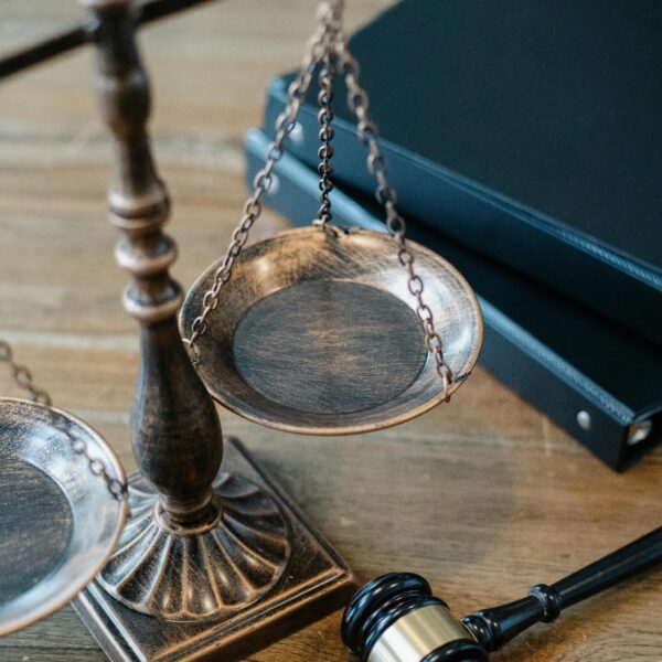 brass lawyer scale of justice with gavel and law books