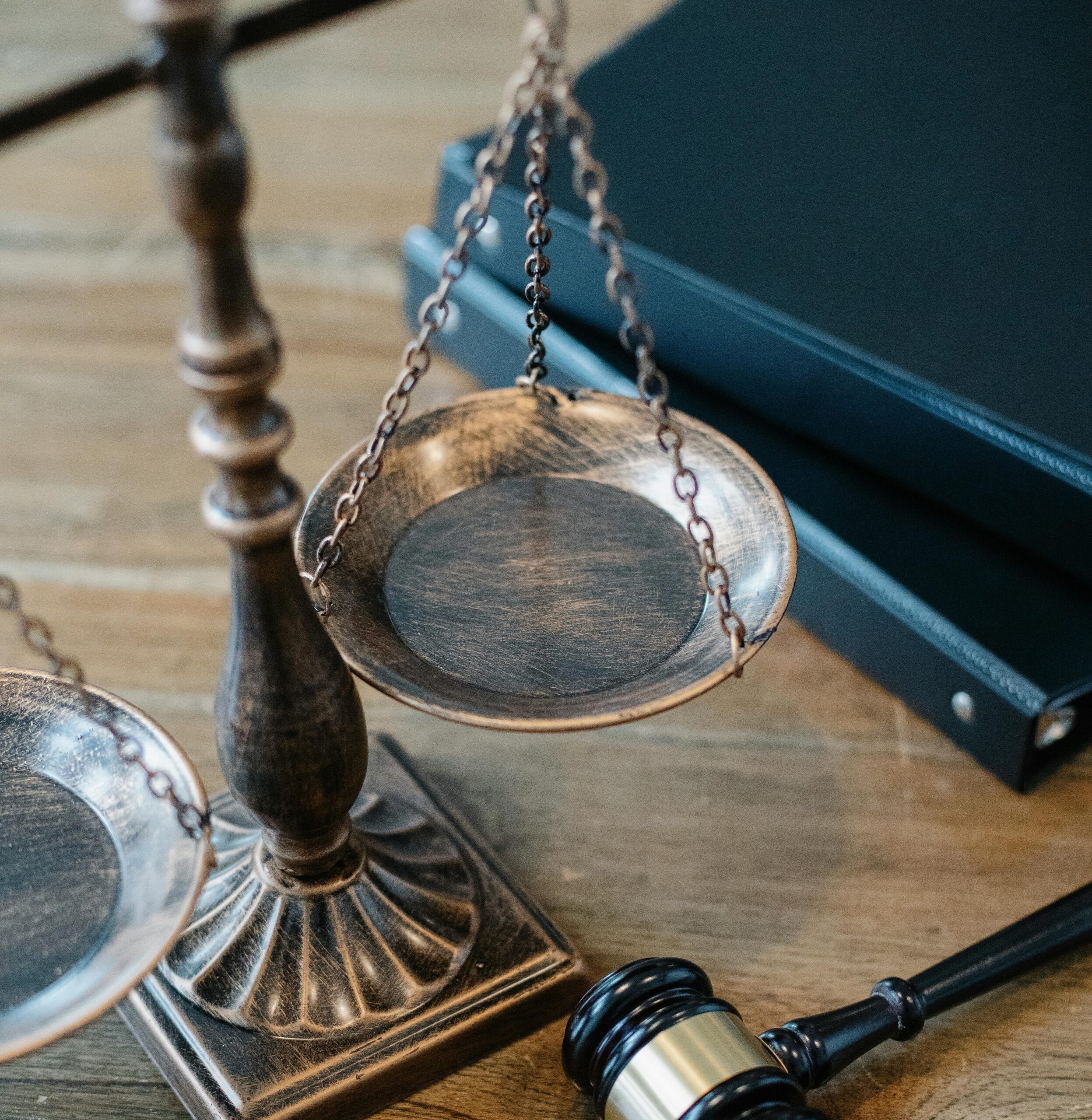 brass lawyer scale of justice with gavel and law books